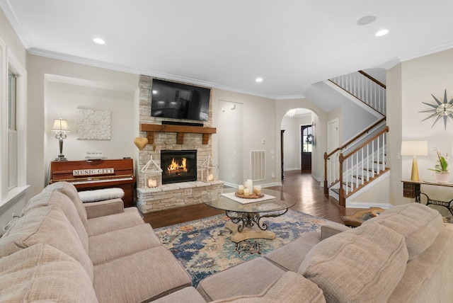 410 Pastoral Way, Nolensville, TN 37135 - living room with arched walkways, wood finished floors, stairs, ornamental molding, and recessed lighting