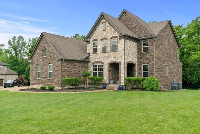 410 Pastoral Way, Nolensville, TN 37135 - french provincial home with a front yard, central air condition unit, brick siding, and roof with shingles