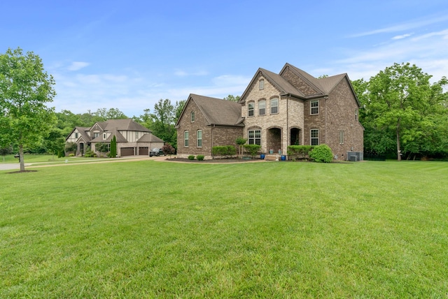 410 Pastoral Way, Nolensville, TN 37135 - french provincial home featuring a front yard, brick siding, and cooling unit
