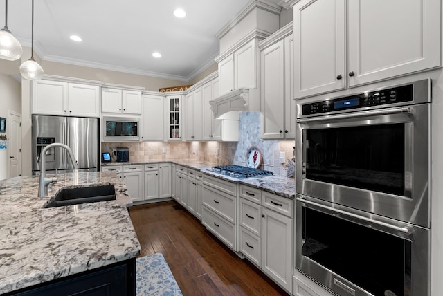 410 Pastoral Way, Nolensville, TN 37135 - kitchen featuring stainless steel appliances, a sink, crown molding, white cabinetry, and glass insert cabinets