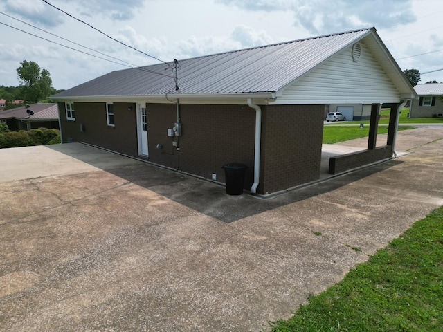 910 Hassell Dr, Waynesboro, TN 38485 - view of home's exterior with brick siding and metal roof