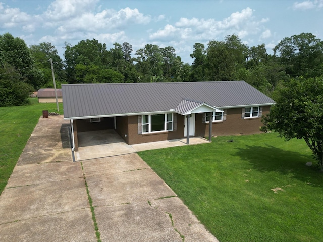 910 Hassell Dr, Waynesboro, TN 38485 - single story home featuring metal roof, brick siding, a front yard, and a carport