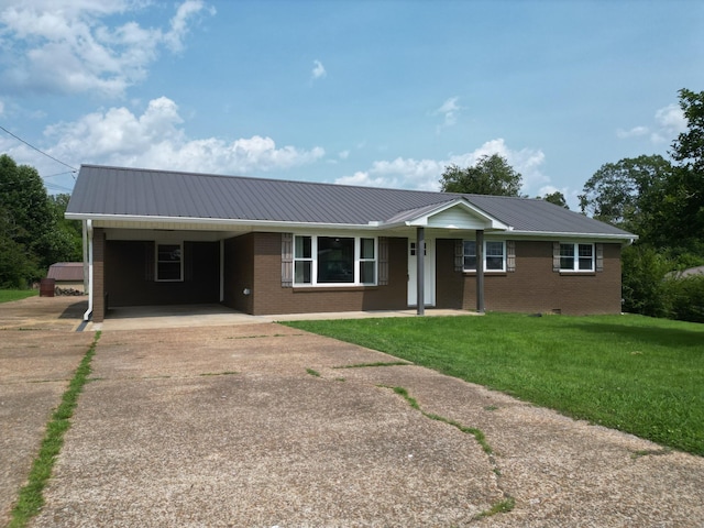 910 Hassell Dr, Waynesboro, TN 38485 - ranch-style house featuring driveway, brick siding, metal roof, a front lawn, and a carport
