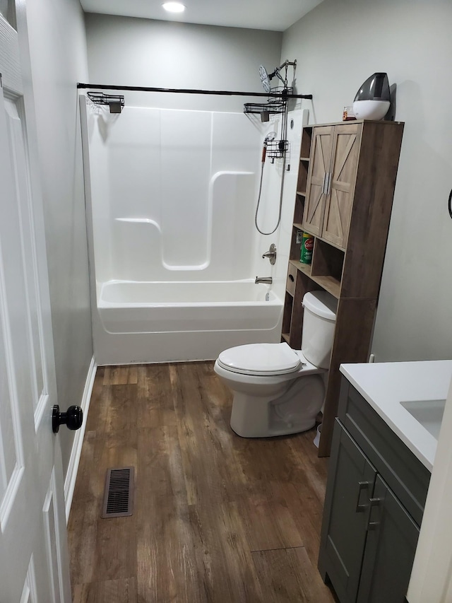 910 Hassell Dr, Waynesboro, TN 38485 - full bathroom featuring toilet, vanity, wood finished floors, and shower / bathtub combination