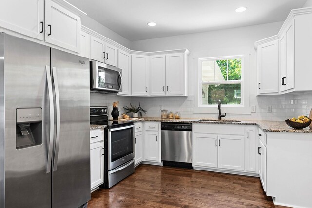 1105 Sunnymeade Dr, Nashville, TN 37216 - kitchen with appliances with stainless steel finishes, a sink, light stone counters, white cabinets, and recessed lighting