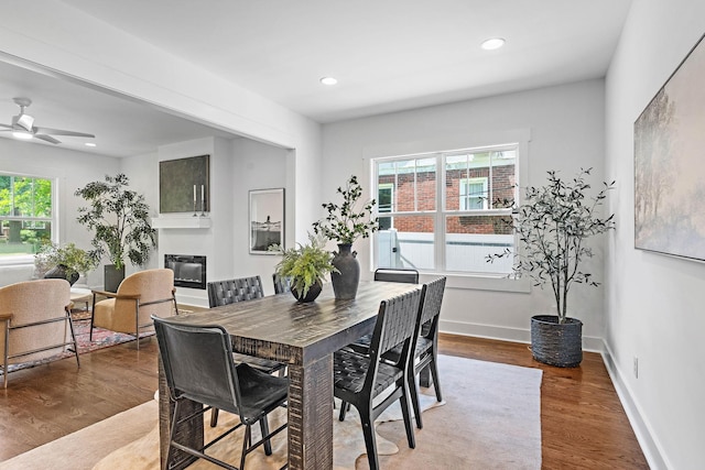 1105 Sunnymeade Dr, Nashville, TN 37216 - dining space featuring a glass covered fireplace, wood finished floors, ceiling fan, baseboards, and recessed lighting