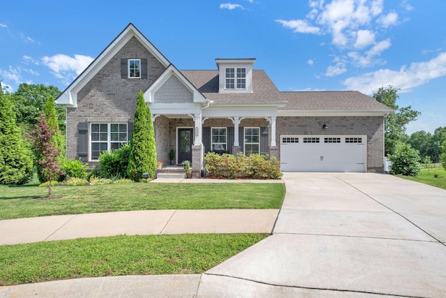 436 Butler Rd, Mount Juliet, TN 37122 - craftsman-style house with an attached garage, a front yard, concrete driveway, covered porch, and brick siding