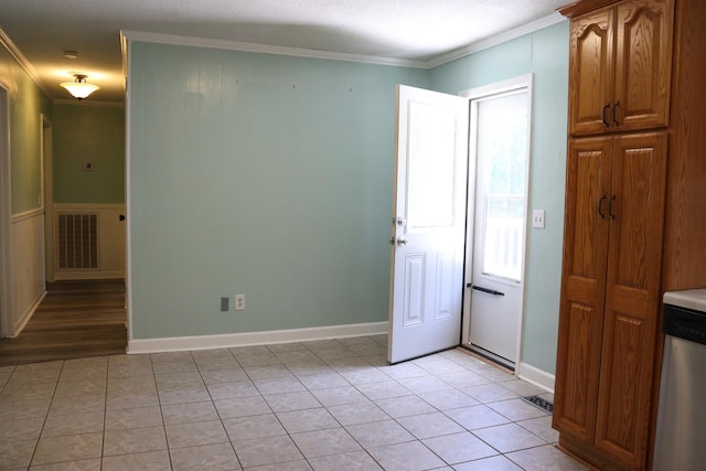 90 Laurel Ln, Paris, TN 38242 - kitchen featuring crown molding, light tile patterned flooring, dishwasher, and brown cabinetry