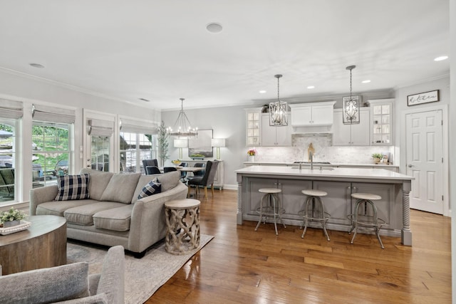 1018 Buddleia Ln, Franklin, TN 37067 - living area featuring ornamental molding, wood finished floors, a chandelier, and recessed lighting