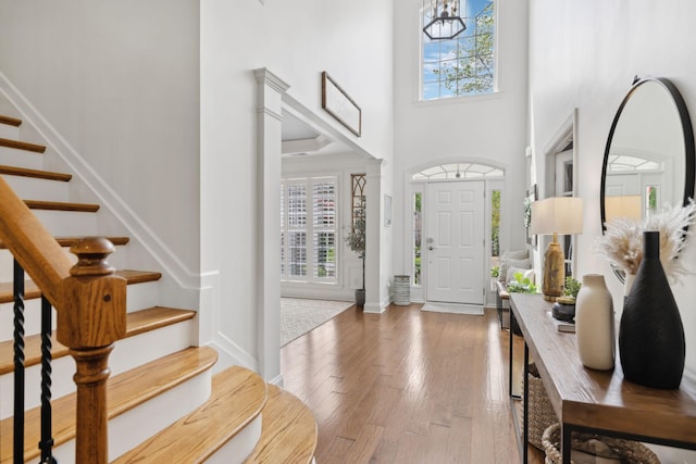 1018 Buddleia Ln, Franklin, TN 37067 - foyer featuring healthy amount of natural light, stairs, hardwood / wood-style floors, a towering ceiling, and baseboards