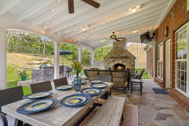 1018 Buddleia Ln, Franklin, TN 37067 - view of patio with an outdoor stone fireplace, ceiling fan, and outdoor dining space