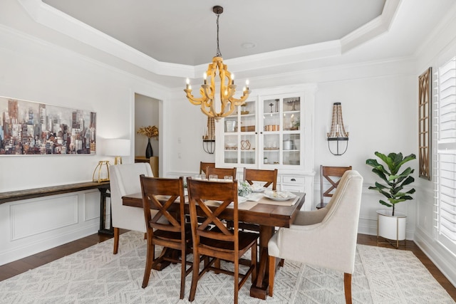 1018 Buddleia Ln, Franklin, TN 37067 - dining space featuring a chandelier, ornamental molding, a raised ceiling, and wood finished floors