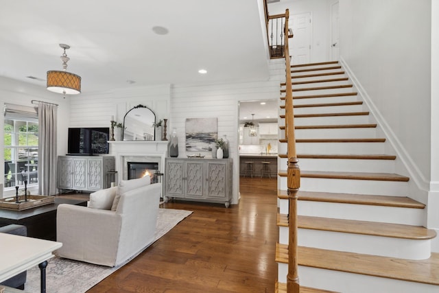 1018 Buddleia Ln, Franklin, TN 37067 - living area featuring stairs, wood finished floors, a glass covered fireplace, and recessed lighting