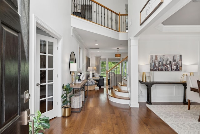 1018 Buddleia Ln, Franklin, TN 37067 - entryway featuring stairs, wood finished floors, a towering ceiling, decorative columns, and ornamental molding