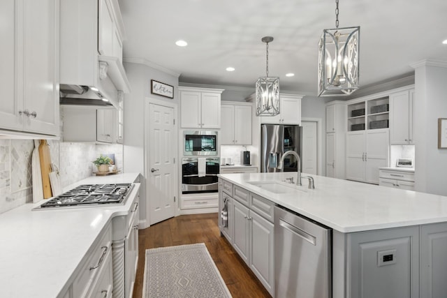 1018 Buddleia Ln, Franklin, TN 37067 - kitchen with stainless steel appliances, a chandelier, crown molding, light countertops, and tasteful backsplash