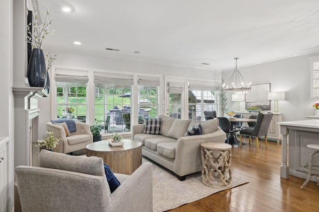 1018 Buddleia Ln, Franklin, TN 37067 - living area featuring a chandelier, ornamental molding, wood finished floors, and recessed lighting