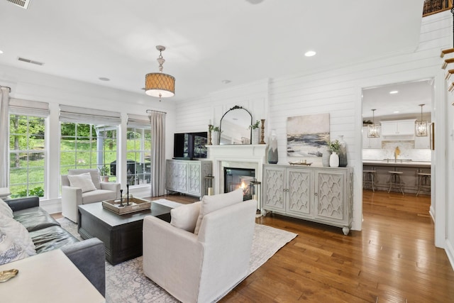 1018 Buddleia Ln, Franklin, TN 37067 - living room with hardwood / wood-style floors, a glass covered fireplace, and recessed lighting
