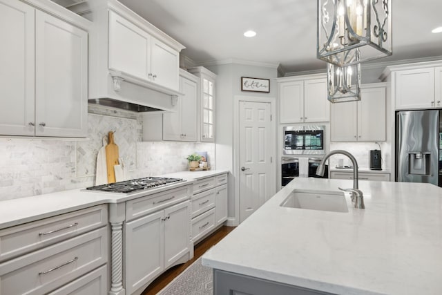 1018 Buddleia Ln, Franklin, TN 37067 - kitchen featuring appliances with stainless steel finishes, ornamental molding, white cabinets, a chandelier, and recessed lighting