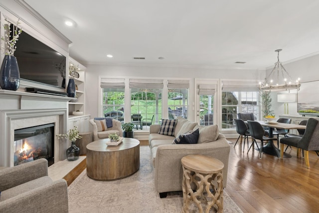 1018 Buddleia Ln, Franklin, TN 37067 - living area featuring ornamental molding, wood finished floors, a high end fireplace, a chandelier, and recessed lighting