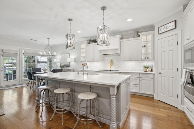 1018 Buddleia Ln, Franklin, TN 37067 - kitchen with a sink, appliances with stainless steel finishes, a kitchen breakfast bar, crown molding, and decorative backsplash