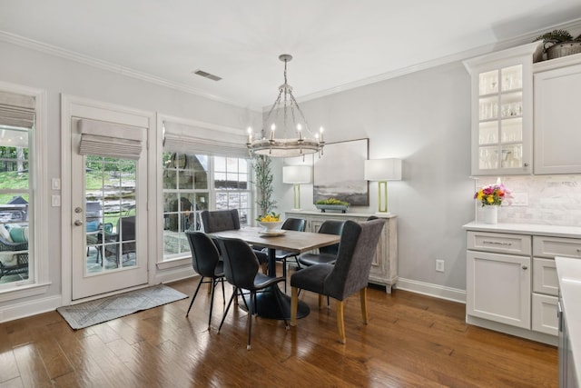 1018 Buddleia Ln, Franklin, TN 37067 - dining space featuring a chandelier, crown molding, hardwood / wood-style floors, and baseboards