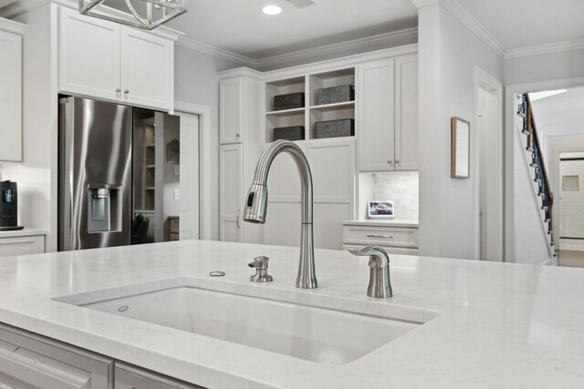 1018 Buddleia Ln, Franklin, TN 37067 - kitchen featuring stainless steel fridge, open shelves, a sink, white cabinetry, and light stone counters