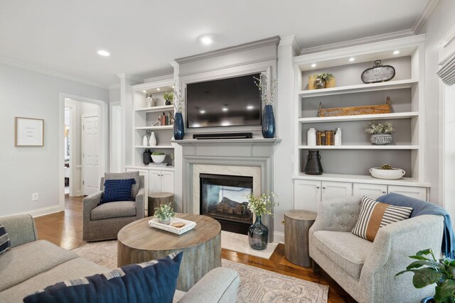 1018 Buddleia Ln, Franklin, TN 37067 - living room featuring baseboards, ornamental molding, a fireplace, built in features, and recessed lighting
