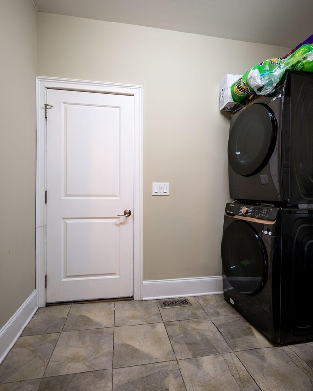 2290 Osburn Rd, Arrington, TN 37014 - washroom with stacked washer and clothes dryer and baseboards