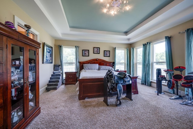 2290 Osburn Rd, Arrington, TN 37014 - carpeted bedroom featuring multiple windows, a tray ceiling, and a chandelier