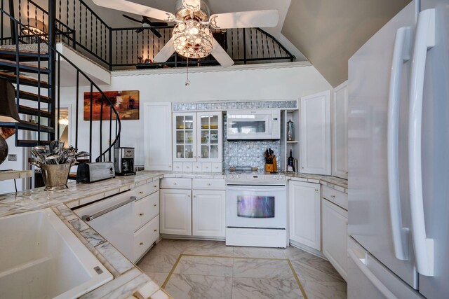 2290 Osburn Rd, Arrington, TN 37014 - kitchen with white appliances, ceiling fan, light marble finish flooring, white cabinetry, and tasteful backsplash