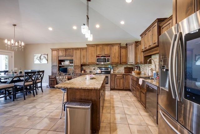 2290 Osburn Rd, Arrington, TN 37014 - kitchen featuring stainless steel appliances, brown cabinets, vaulted ceiling, tasteful backsplash, and a chandelier