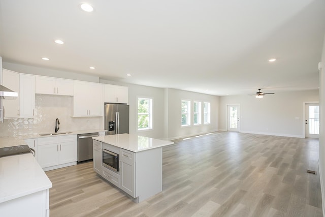 1137 Lawrence Ave Unit 1, Madison, TN 37115 - kitchen with appliances with stainless steel finishes, a sink, backsplash, recessed lighting, and ceiling fan