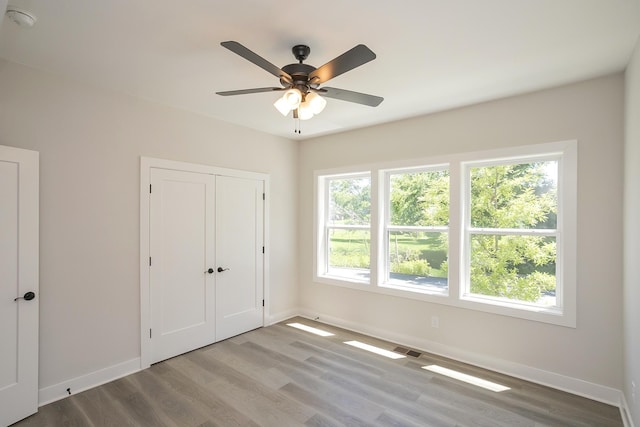 1137 Lawrence Ave Unit 1, Madison, TN 37115 - unfurnished bedroom featuring baseboards, wood finished floors, a closet, and a ceiling fan