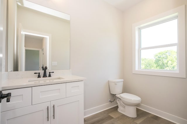 1137 Lawrence Ave Unit 1, Madison, TN 37115 - half bathroom featuring baseboards, toilet, wood finished floors, and vanity