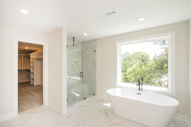1137 Lawrence Ave Unit 1, Madison, TN 37115 - bathroom with marble look tile flooring, a marble finish shower, recessed lighting, a freestanding bath, and baseboards