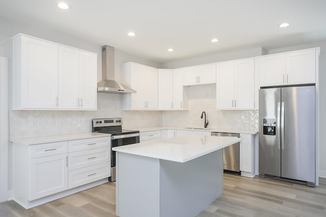 1137 Lawrence Ave Unit 1, Madison, TN 37115 - kitchen with appliances with stainless steel finishes, wall chimney range hood, a sink, light wood-type flooring, and recessed lighting