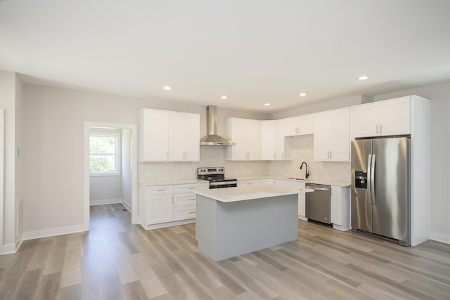 1137 Lawrence Ave Unit 1, Madison, TN 37115 - kitchen featuring appliances with stainless steel finishes, wall chimney range hood, a sink, a kitchen island, and backsplash