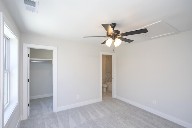 1137 Lawrence Ave Unit 1, Madison, TN 37115 - unfurnished bedroom with light colored carpet, a walk in closet, baseboards, attic access, and a closet