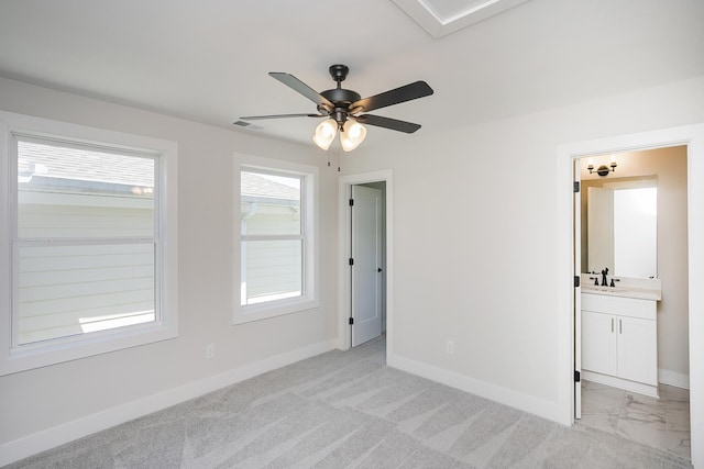 1137 Lawrence Ave Unit 1, Madison, TN 37115 - unfurnished bedroom featuring a sink, baseboards, ensuite bath, and a ceiling fan
