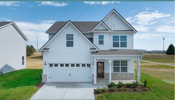 1065 Ewell Farm Cir, Spring Hill, TN 37174 - craftsman-style house with a porch, a front lawn, concrete driveway, and a garage