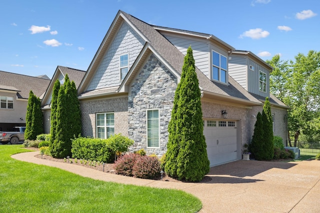 4136 Banner Square Ln, Arrington, TN 37014 - view of side of property with driveway, an attached garage, and stone siding
