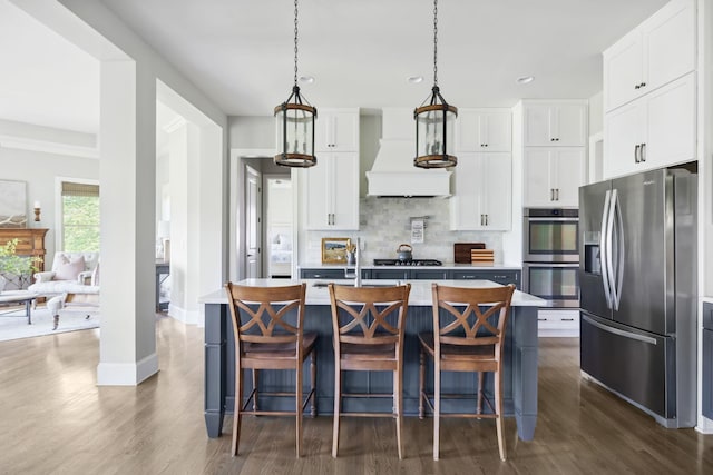 4136 Banner Square Ln, Arrington, TN 37014 - kitchen with appliances with stainless steel finishes, custom exhaust hood, dark wood-type flooring, backsplash, and light countertops