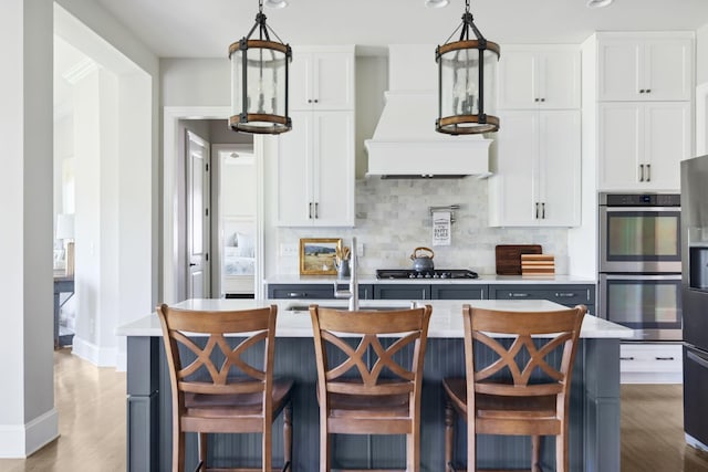4136 Banner Square Ln, Arrington, TN 37014 - kitchen with stainless steel double oven, light countertops, backsplash, white cabinets, and recessed lighting