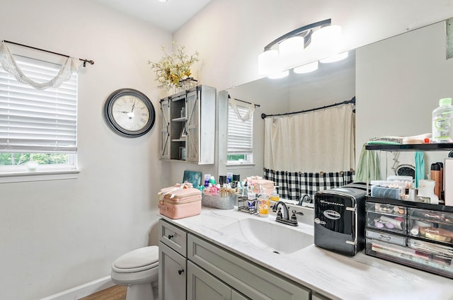 2328 C C C Rd, Dickson, TN 37055 - bathroom featuring toilet, vanity, a shower with shower curtain, wood finished floors, and baseboards