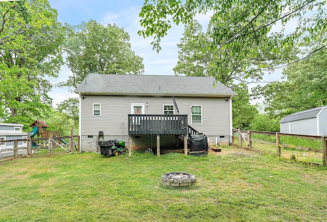 2328 C C C Rd, Dickson, TN 37055 - rear view of property featuring crawl space, a deck, a gate, a fire pit, and a shingled roof