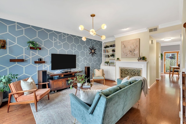 2112 Blair Blvd Unit 8, Nashville, TN 37212 - living room with light wood-style floors, crown molding, a chandelier, baseboards, and built in shelves