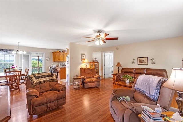 4190 Tanyard Hill Rd, Lynchburg, TN 37352 - living room with a ceiling fan, light wood-type flooring, and a chandelier