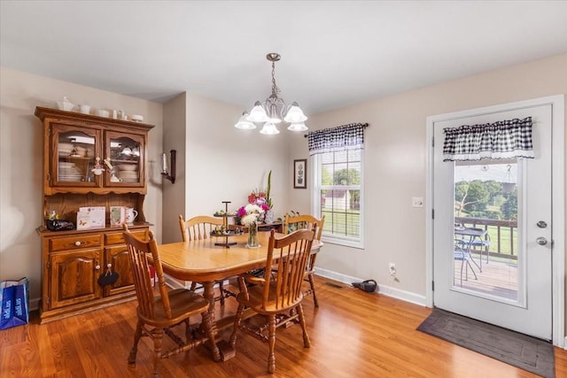 4190 Tanyard Hill Rd, Lynchburg, TN 37352 - dining space with light wood-style floors, a chandelier, and baseboards