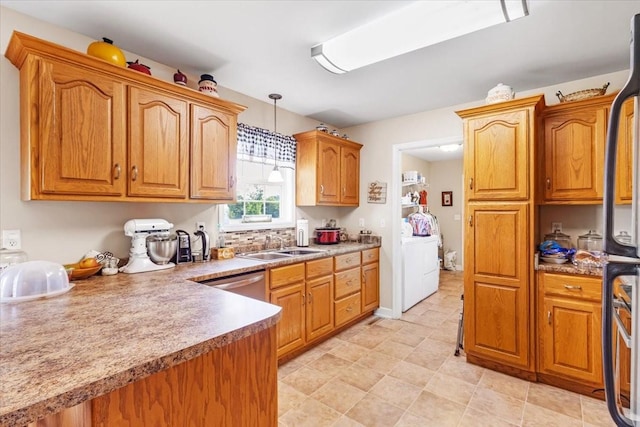 4190 Tanyard Hill Rd, Lynchburg, TN 37352 - kitchen featuring a sink, pendant lighting, washing machine and dryer, and brown cabinets