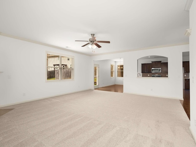 3029 Alan Dr, Spring Hill, TN 37174 - unfurnished living room featuring carpet floors, ceiling fan, crown molding, and baseboards